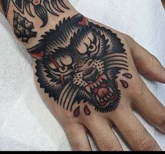 a man's hand with a tattoo on it and a tiger head in the middle