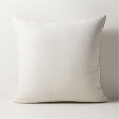 a white pillow sitting on top of a table