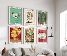 a living room filled with white furniture and posters on the wall above a coffee table