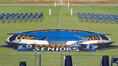 a field with chairs and a sign that says seniors