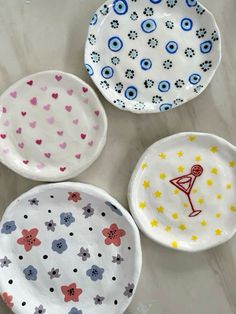 three plates with different designs on them sitting on a counter top next to each other