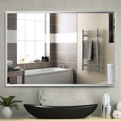 a bathroom mirror with a reflection of a bathtub and sink in the background,