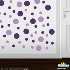 purple and gray polka dot wall decals on a white door with wooden flooring