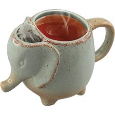 an elephant shaped tea cup is shown with its trunk sticking out