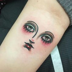 a woman's face with eyes and eyelashes on her arm