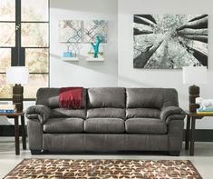 a living room scene with focus on the couch and coffee table in the foreground