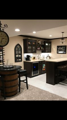 a home bar with stools and a clock on the wall