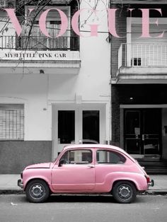 an old pink car parked in front of a building with the word voquet on it