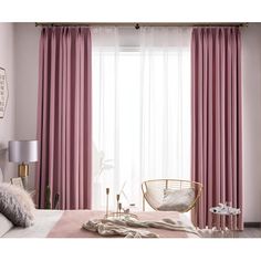 a bedroom with pink curtains and white bedding