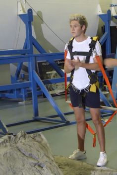 a young man with a backpack is standing in front of some equipment