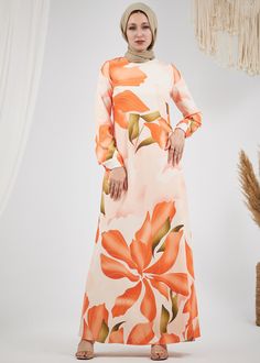 Step into elegance with our Radiant Floral Satin Maxi Dress. This stunning piece features a captivating floral pattern in vibrant hues of orange and green, making it a perfect choice for any special occasion. Crafted from luxurious satin, the dress is fully lined for comfort and modesty. The design includes long, subtly flared sleeves and a chic high neck, adding a touch of sophistication to your look. The dress is beautifully tailored with a matching belt that cinches the waist, creating a flat Maxi Dress With Belt, Modest Activewear, Full Coverage Swimsuit, Bold Floral Print, Abaya Dress, Orange And Green, Satin Maxi, Dress With Belt, Satin Maxi Dress