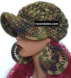 a close up of a mannequin head wearing a hat with large hoop earrings