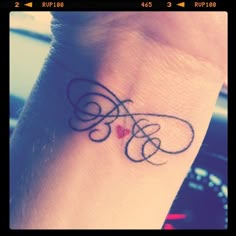 a small tattoo on the wrist of a woman's left arm with an infinite symbol