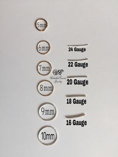 some type of magnets that are on a white surface with measurements for each one