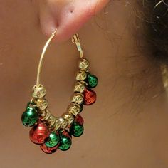 'Tis the season for jingly-jangly joy! Deck out your lobes with these Christmas Jingle Hoop Earrings. A pair of 2x2" merry-n-bright gold hoops adorned with green and red Christmas bells. A festive addition sure to make the season shine. Jingle Bell Earrings Diy, Festive Nickel-free Dangle Hoop Earrings, Holiday Festive Nickel-free Jewelry, Nickel-free Dangle Hoop Earrings For Festive Occasions, Nickel-free Jewelry For Festive Holidays, Nickel-free Jewelry For Festive Holiday, Green Dangle Hoop Earrings For Celebration, Green Jewelry For New Year's Party, Green Jewelry For New Year Party