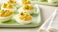 deviled eggs are arranged on a green tray