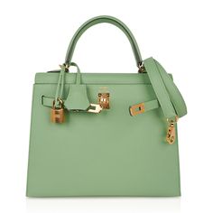 Guaranteed authentic Hermes Kelly Sellier 25 bag featured in fresh Vert Criquet. Stunning Hermes light green that is absolutely neutral. Luxurious with gold hardware. Comes with signature Hermes box, raincoat, shoulder strap, sleepers, lock, keys and clochette. NEW or NEVER WORNThe Hermes Kelly Sellier 25cm bag price retains its value due to the rarity and high demand. As a purveyor of exceptional and unique Hermes luxury goods, mightychic raises the bar of online shopping.final sale BAG MEASURE Luxury Green Bags With Lock, Luxury Green Bag With Lock, Designer Green Satchel With Branded Hardware, Green Elegant Satchel With Branded Hardware, Luxury Green Satchel With Handles, Elegant Green Satchel With Branded Hardware, Classic Green Satchel With Branded Hardware, Green Leather Satchel With Gold-tone Hardware, Classic Green Bag With Gold-tone Hardware