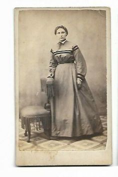 an old photo of a woman in a dress