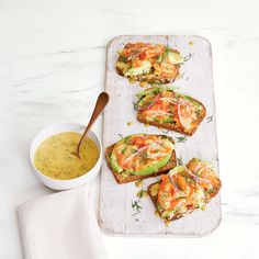 toasted sandwiches with avocado, tomato and mayonnaise on a tray