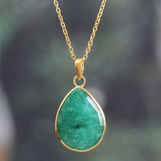 Flaunt your refined taste with this breathtaking pendant necklace, a sophisticated statement piece made for turning heads. The 17-carat beryl gemstone demands to be admired, its rich green hue seemingly plucked from a lush rainforest. Indian artisan Neetu Barathi's precious creation balances the stone's grandeur with a radiant 18k gold-plated adjustable cable chain designed to catch the light at every turn. Luxury Pear-shaped Emerald Gemstone Necklace, Formal Drop Emerald Gemstone Necklace, Luxury Teardrop Emerald Necklace Gift, Luxury Teardrop Emerald Necklace For Gift, Luxury Emerald Gemstone Pendant Necklace, Luxury Green Emerald Oval Pendant Necklace, Luxury Green Pear-shaped Emerald Necklace, Luxury Green Teardrop Pendant Necklace, Elegant Drop Emerald Necklace For Gift