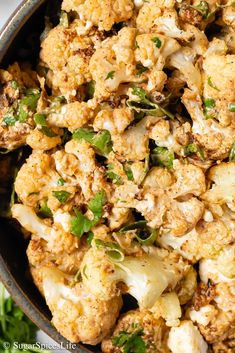 a bowl filled with cauliflower and herbs