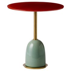 a red and green table with a gold base on white backgrounge background