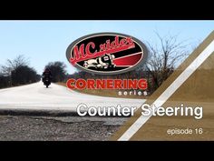 a motorcycle driving down a road next to a sign with the words cornerings on it