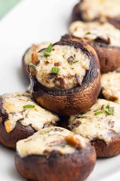 mushrooms stuffed with cheese and herbs on a white plate