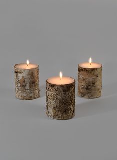 three lit candles sitting next to each other