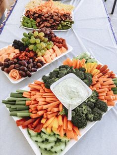 several platters of vegetables and dip on a table