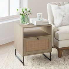 a living room with a chair, table and flowers on the coffee table next to it