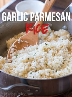 garlic parmesan rice in a pan with a wooden spoon