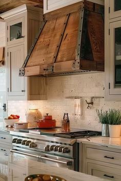 a kitchen with an oven, stove and counter tops in white painted wood paneling