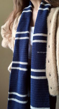 a doll wearing a blue and white striped scarf