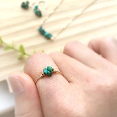 ✨ Raw Turquoise Ring 14K Gold Filled - Sterling Silver, Tiny Raw Stone Stacking Ring, December Birthstone, Pinky ring💙 Dainty & cute stacking ring with genuine Turquoise raw beads. Make a lovely everyday ring, pinky ring, and a wonderful gift.Sizing: •Gemstone Diameter: 4 mm•Ring Band:  0.8 mm ✨ Turquoise is a good luck charm for health and abundance. It is also said to have a therapeutic benefit of tranquility and calmness ✨• Handmade in your ring size with 14K gold-filled or sterling silv Adjustable Turquoise Jewelry For May Birthstone, Dainty 14k Gold Turquoise Gemstone Ring, Dainty 14k Gold Turquoise Ring, 14k Gold Green Turquoise Ring As A Gift, Turquoise Birthstone Promise Ring, Turquoise Rings For May Birthstone Gifts, Green Wire Wrapped Rings, Green Wire Wrapped Rings For Jewelry Making, Green Wire Wrapped Promise Ring