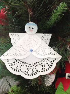 an ornament hanging from a christmas tree in the shape of a angel with wings