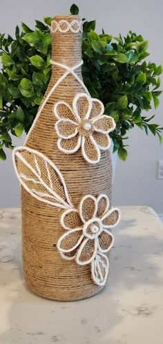 a bottle with some flowers on it sitting on a table