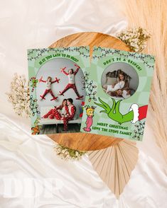 two christmas cards on top of a wooden table