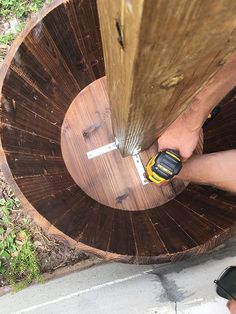 a man is using a drill to repair a piece of wood