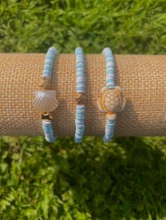 Beautiful preppy style bracelet set - pack of 3 bracelets with a beautiful beach / sea theme. The 3 bracelets are between 16cm and 18cm in length, which is suitable for most sizes of wrist as they are quite stretchy. Handmade in the UK The elastic string will stretch slightly with wear, but please do not over stretch the bracelets as they may break. The patterns might vary slightly from the photos, but the same colours will be used. FAST DISPATCH!* All orders are always shipped same-day with fas Cute Adjustable Stretch Bracelet For Beach, Beachy Friendship Bracelets With Letter Beads, Beachy Friendship Bracelets For Beach Party, Adjustable Stretch Bracelet For Beach, Adjustable Stretch Bracelet For Beach Season, Beachy Strand Friendship Bracelets For Beach Party, Turquoise Letter Beads Friendship Bracelets For Beach, Blue Strand Friendship Bracelets For Beach Season, Cute Stretch Bracelet With Letter Beads For Beach