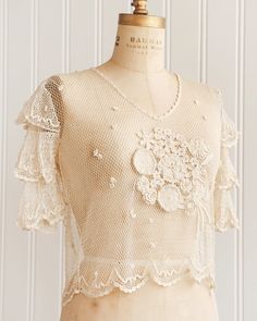 Feminine Short Sleeve Lace Crochet Top, Cream Lace Top With Crochet Details, Cream Lace Blouse With Crochet Detail, Cream Lace Tops With Crochet Trim, Beige Crochet Lace Top With Lace Trim, Cream Lace Blouse With Crochet Trim, Spring Vintage Crochet Top With Lace Work, Vintage Lace Patchwork Tops For Summer, Fitted Cotton Lace Tops With Crochet Trim