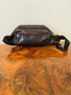 "Brown leather Fanny Pack, Leather ,Hip Bag ,Dark Chocolate Brown Gorgeous soft genuine dark chocolate leather fanny hip bag Made in Mexico 2 side zip pockets 1 back zip pocket 1 front pocket w/velcro closure Top zippered closure PLEASE SEE MEASUREMENTS Measures: 14\" x 6\" x 3\"1/2 Strap: 34' adjustable Excellent condition: clean, looks unused NK246 NK334 Brown leather Fanny Pack, Leather ,Hip Bag ,Dark Chocolate Brown" Brown Pouch Belt Bag With Pockets, Brown Pouch Belt Bag With Zipper, Brown Belt Bag With Zipper Pouch, Brown Leather Shoulder Bag With Zipper Pouch, Brown Leather Belt Bag With Zipper Closure, Brown Soft Leather Travel Belt Bag, Brown Crossbody Belt Bag With Zipper Pouch, Brown Crossbody Belt Bag With Zipper, Leather Hip Bag