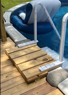 an inflatable boat floating on top of a wooden deck next to a swimming pool