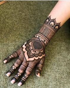 a woman's hand with hennap on it, showing the intricate design