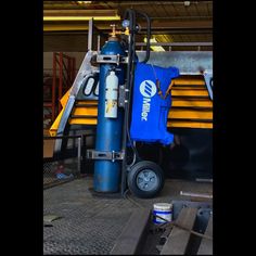 a blue fire extinguisher sitting on top of a floor