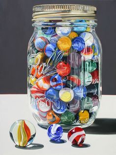 a jar filled with lots of colorful glass marbles