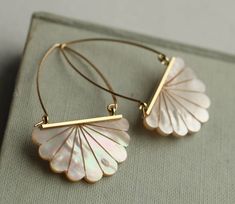 These beautiful Art Deco earrings are pure Mother of Pear,l which has been carved into a simple scalloped fan shape. The pearl has an incredible sheen and takes on a subtle glow when they catch the light. They are finished with solid brass ear wires, designed to hang just below the earlobe. The length of the earrings is around 40mm (around an inch and a half). Art Deco Pendant Necklace, Pearl Art, Statement Earrings Wedding, Silk Purse, Bridal Wedding Earrings, Deco Earrings, Vintage Boho Fashion, Art Deco Pendant, Ear Earrings