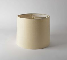 a white lamp shade sitting on top of a table