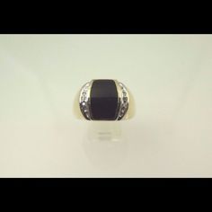 Hi, Here We Have A Beautiful 10k Two Tone Gold Black Onyx With Diamonds Men's Ring. Weight Is 8.7g. Width Is 14.85mm. Ring Has Three Brilliant Round Cut Diamonds On Each Side Of The Black Onyx Totaling Approximately 0.05ct. The Perfect Gift For Your Loved One. Buy With Confidence, We Only Sell Top Quality Items. Comes With A Free Gift Box. Metal: Two Tone Gold (White/Yellow) Main Stone Color: Black Metal Purity: 10k Occasion: Birthday Sizable: Yes Ring Size: 13.5 Main Stone: Onyx Formal Black Rings With Accent Stones, Classic Black Rings With Accent Stones, Classic Black Diamond Rings For Formal Occasions, Black Diamond Ring With Accent Stones For Formal Occasions, Formal Black Diamond Ring With Accent Stones, Classic Black Diamond Ring With Black Enamel, Formal Black Diamond Ring With Diamond Accents, Gold Diamond Ring With Black Diamonds For Formal Events, Gold Diamond Ring With Black Diamonds For Formal Occasions