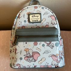 Loungefly Uk Exclusive Baby Blue Dumbo Mini Backpack. Retro Disney Print Allover With Blue Straps And Adorable Baby Pink And White Striped Interior Fabric. The One For Sale Is Still Sealed In Package And Has Not Been Opened, New With Tags. Hard To Find This Print In The Blue, Rare Beauty! My Little Pony Backpack, Cinderella Mice, Striped Interior, Disney 50th Anniversary, Disney Brave, Retro Disney, Disney Print, Mini Backpacks, Grey Backpacks